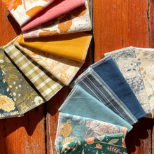 Load image into Gallery viewer, A colorful array of Ray’s Reusables zero waste paperless towels are fanned out on a wood backdrop
